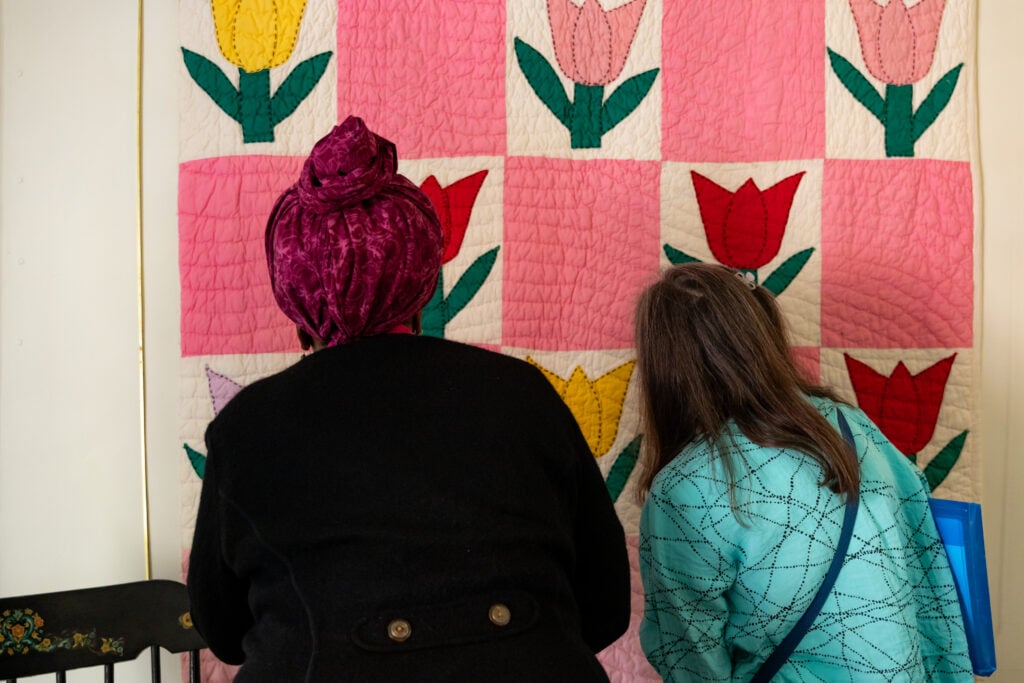 Jeanette and Jereann look at a quilt